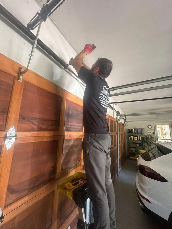 Technician inspecting hardware inside a residential garage